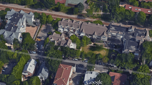 Aerial view from Google, tilted. Rail line is at top, in back of buildings.